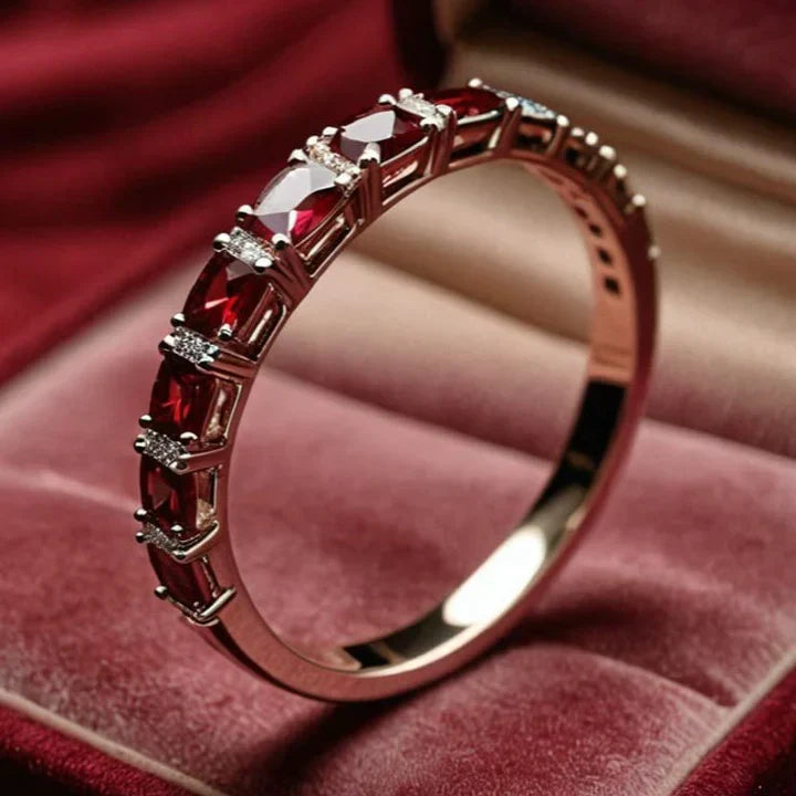 Gold ring with red crystal inlays
